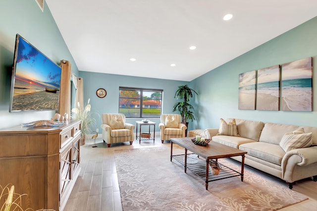 living room featuring lofted ceiling and light wood-type flooring