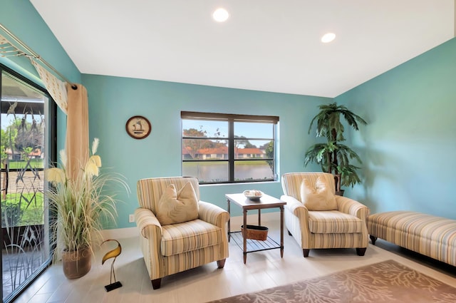 sitting room featuring a wealth of natural light and a water view