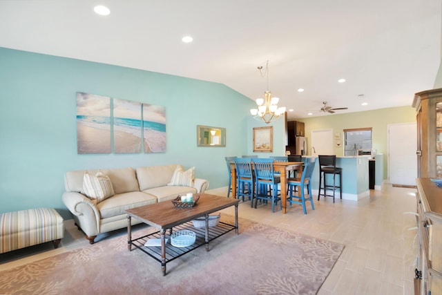 living room with ceiling fan, vaulted ceiling, and light hardwood / wood-style flooring