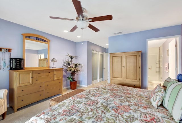 carpeted bedroom with connected bathroom and ceiling fan