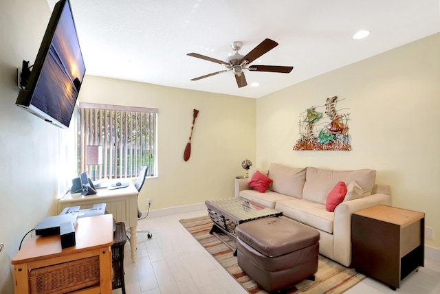 living room featuring light hardwood / wood-style flooring and ceiling fan