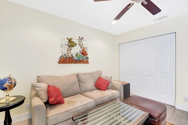 living room with ceiling fan and light hardwood / wood-style floors