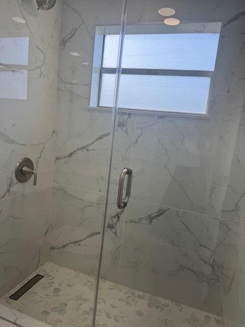 bathroom with a shower with shower door