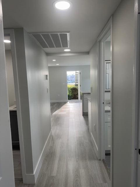 corridor featuring light hardwood / wood-style floors