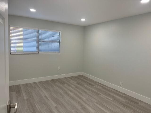 empty room with light hardwood / wood-style floors