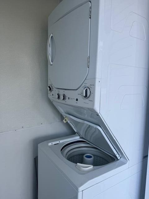 laundry area with stacked washer / drying machine