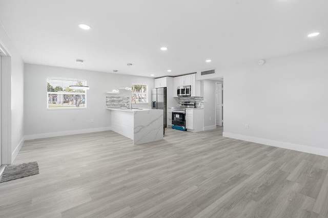 interior space with sink and light wood-type flooring