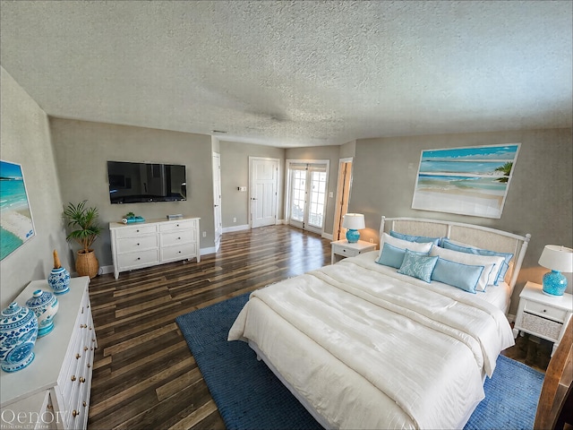 bedroom featuring wood finished floors, a textured ceiling, baseboards, and french doors