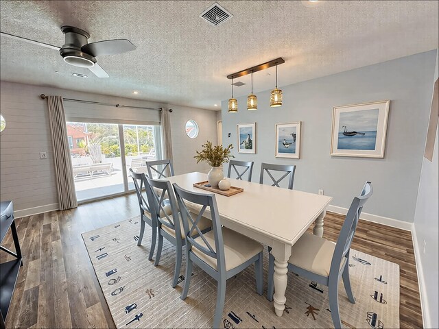 living area featuring light hardwood / wood-style flooring and a textured ceiling