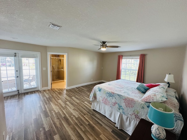 bedroom with ensuite bathroom, a textured ceiling, hardwood / wood-style flooring, ceiling fan, and access to exterior