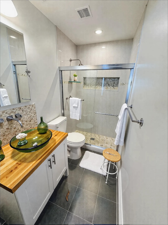 full bath with a shower stall, toilet, tile patterned floors, vanity, and recessed lighting
