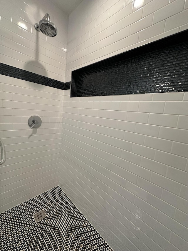 bathroom with a tile shower