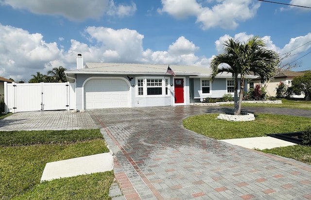 single story home featuring curved driveway, a garage, a gate, and stucco siding