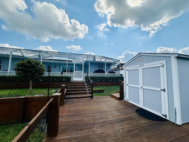 wooden deck with a lanai and a shed