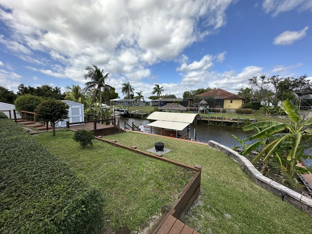 wooden terrace with a lanai and a lawn