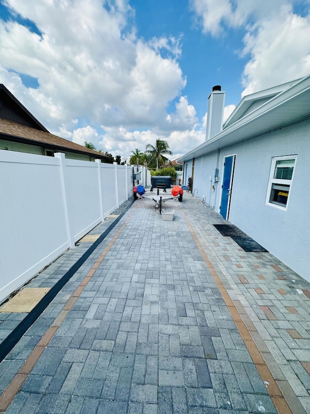 view of patio / terrace featuring fence
