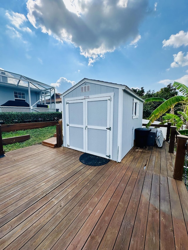 wooden deck featuring a storage unit