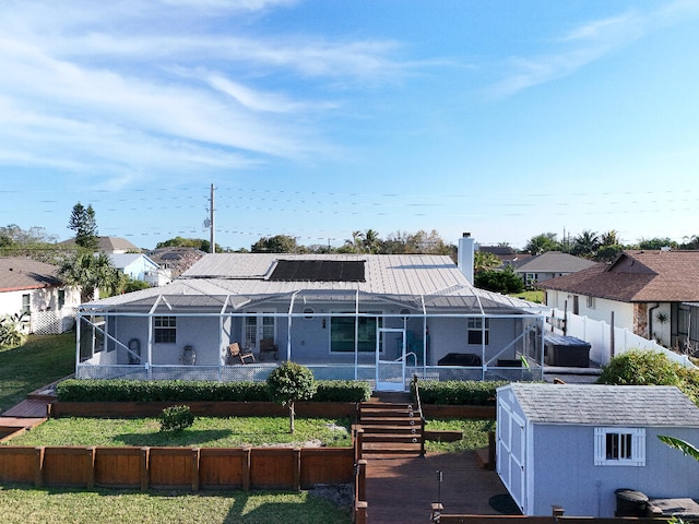back of house with a lanai, a residential view, stairway, and a yard