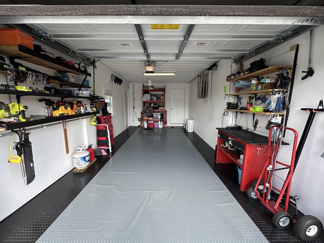 garage featuring a garage door opener and a workshop area