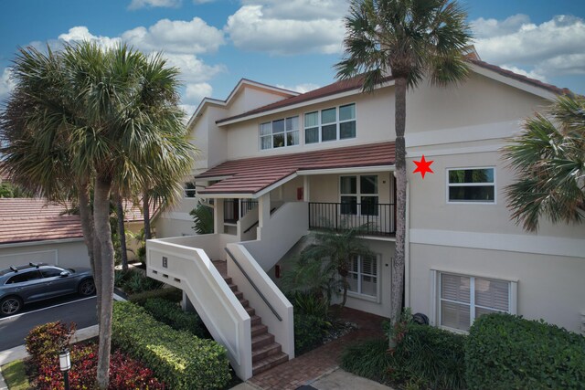 4161 S US Highway 1 Unit E3, Jupiter, FL 33477 - view of front facade with stucco siding and stairs