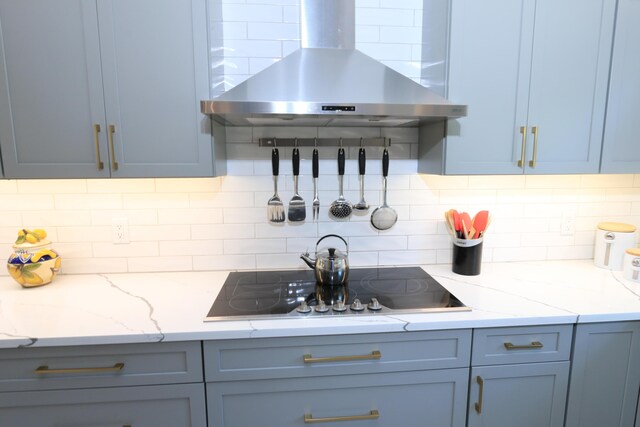 4161 S US Highway 1 Unit E3, Jupiter, FL 33477 - kitchen with range hood, black electric cooktop, decorative backsplash, and light stone countertops