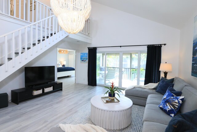 4161 S US Highway 1 Unit E3, Jupiter, FL 33477 - living area featuring high vaulted ceiling, a chandelier, stairs, and wood finished floors