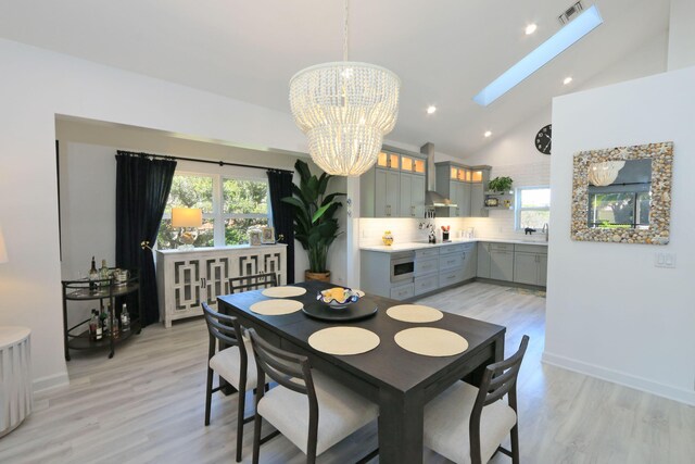 4161 S US Highway 1 Unit E3, Jupiter, FL 33477 - dining room featuring a chandelier, light wood-type flooring, plenty of natural light, a skylight, and recessed lighting