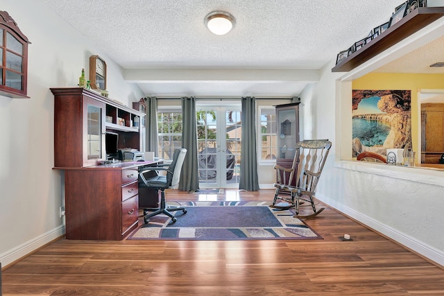 home office with a textured ceiling, baseboards, and wood finished floors