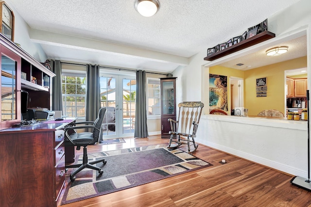 office area with a textured ceiling, french doors, wood finished floors, and baseboards