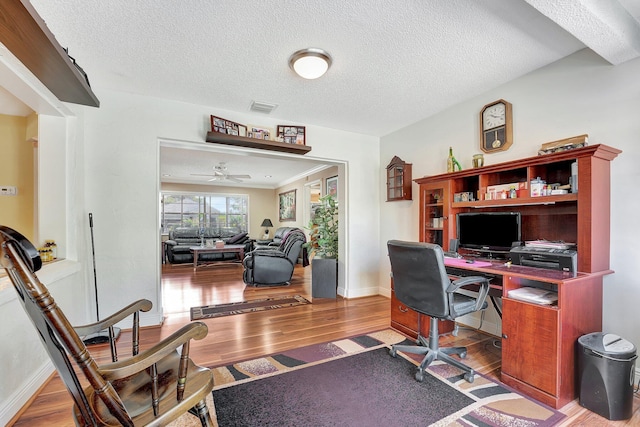 home office with hardwood / wood-style floors, a textured ceiling, and ceiling fan