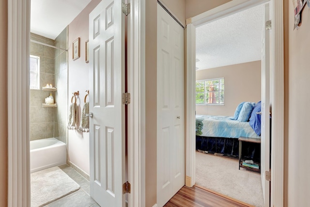 hall with baseboards and a textured ceiling