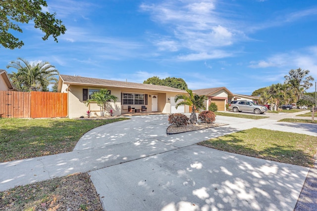 single story home with a garage, a front yard, and a porch