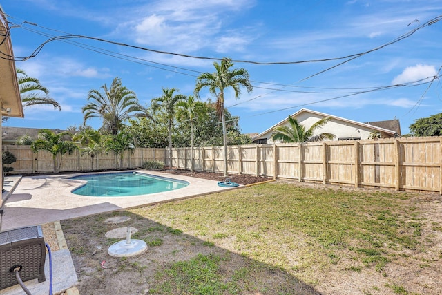 view of swimming pool featuring a lawn and a patio