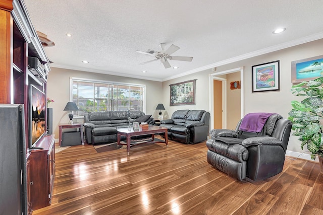 living area with a textured ceiling, recessed lighting, wood finished floors, baseboards, and crown molding