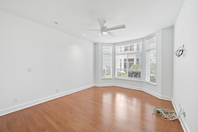 empty room with light hardwood / wood-style flooring and ceiling fan