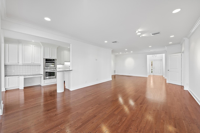 unfurnished living room featuring hardwood / wood-style flooring and ornamental molding