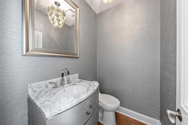 bathroom featuring hardwood / wood-style flooring, vanity, and toilet