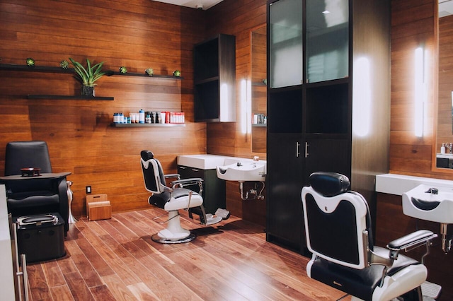 home office with hardwood / wood-style floors and wood walls