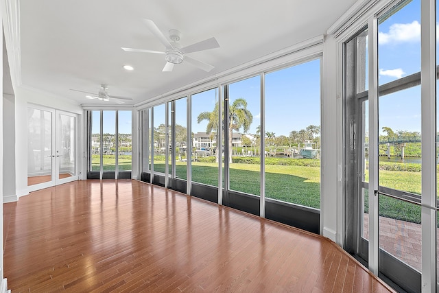 unfurnished sunroom featuring ceiling fan