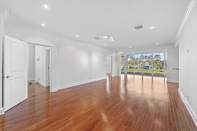 unfurnished living room with crown molding and hardwood / wood-style floors