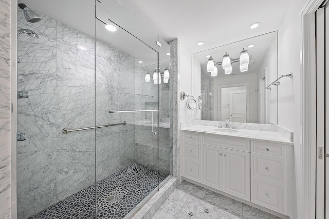 bathroom with vanity and a shower with shower door