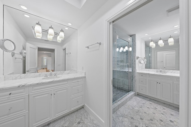 bathroom featuring a shower with door and vanity