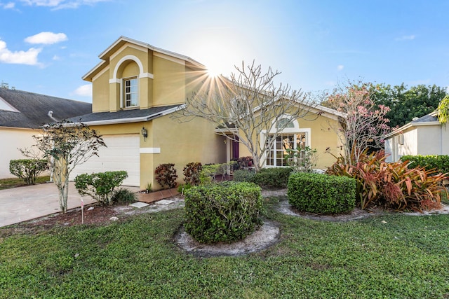 view of front of property with a garage and a front yard