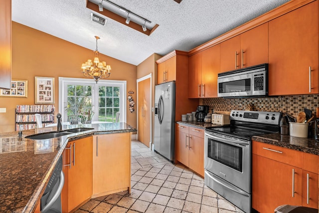 kitchen with tasteful backsplash, sink, vaulted ceiling, and stainless steel appliances