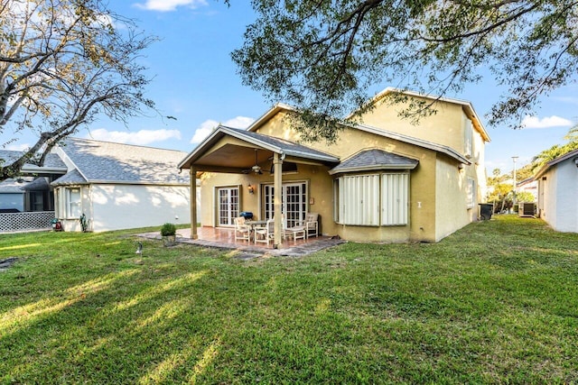 back of property featuring a yard, cooling unit, and ceiling fan