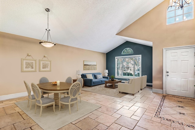 dining area with lofted ceiling and a textured ceiling