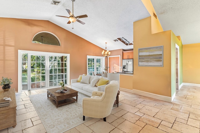 living room with high vaulted ceiling, ceiling fan with notable chandelier, and a textured ceiling