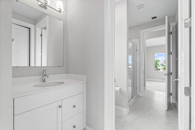 bathroom featuring vanity and a shower with door