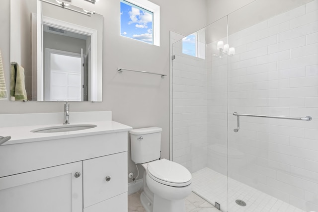 bathroom with vanity, toilet, and a shower with shower door