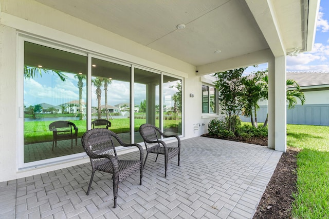 view of patio with a water view